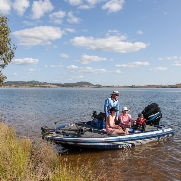 Family fishing on a boat at Somerset Dam