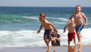 Kids running on the beach at Eastern Beach