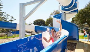 Mother and son sliding down a slide in the waterpark at Victor Harbor