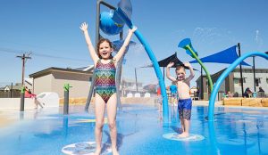 Two children splashing in the water at the waterpark in Victor Harbor