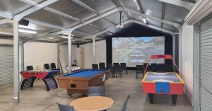 Games room with seating, pool table, air hockey