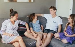 family sitting on couch