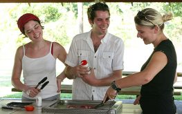 three young people standing around a Cairns caravan park BBQ