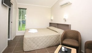 Cairns cabin accommodation with bed, bathroom, living area, TV and air-conditioning
