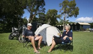 Couple sitting on chairs in front of their tent in a Cairns Holiday Park