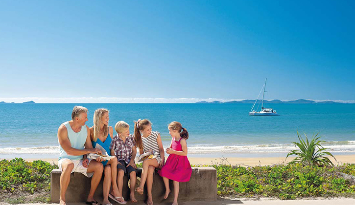 Family of five sitting in front of a beach near Yeppoon