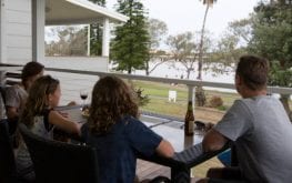 sydney lakeside family sitting at balcony table