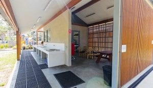 BBQ area and camp kitchen facilities inside a Shellharbour holiday park