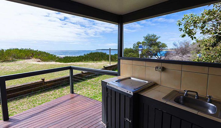 Cabin veranda overlooking the ocean at a Shellharbour caravan park