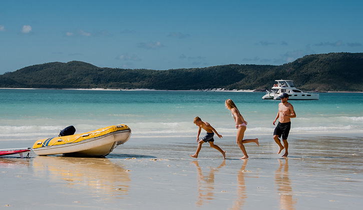 Airlie Beach father and kids with boat