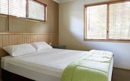 queen bed in villa inside Coffs Harbour accommodation