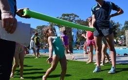 Adults and kids playing near a swimming pool at NRMA Ocean Beach Holiday Resort in Umina Beach