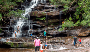 People under Somersby Falls waterfall