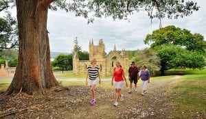 Four people walking on the trail from the historic site to Port Arthur Holiday Park
