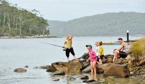 Children fishing from the rocks in Stewarts Bay on the Tasman Peninsula